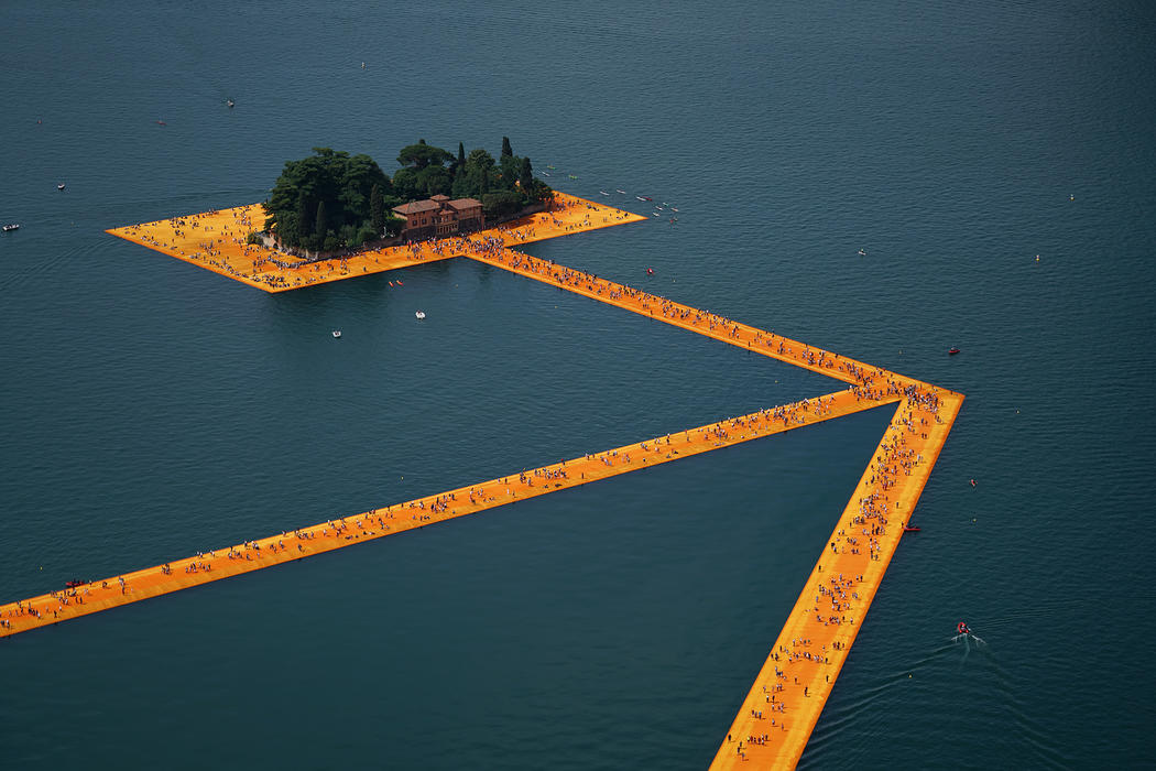 the floating piers opens on lake iseo allowing visitors to "walk